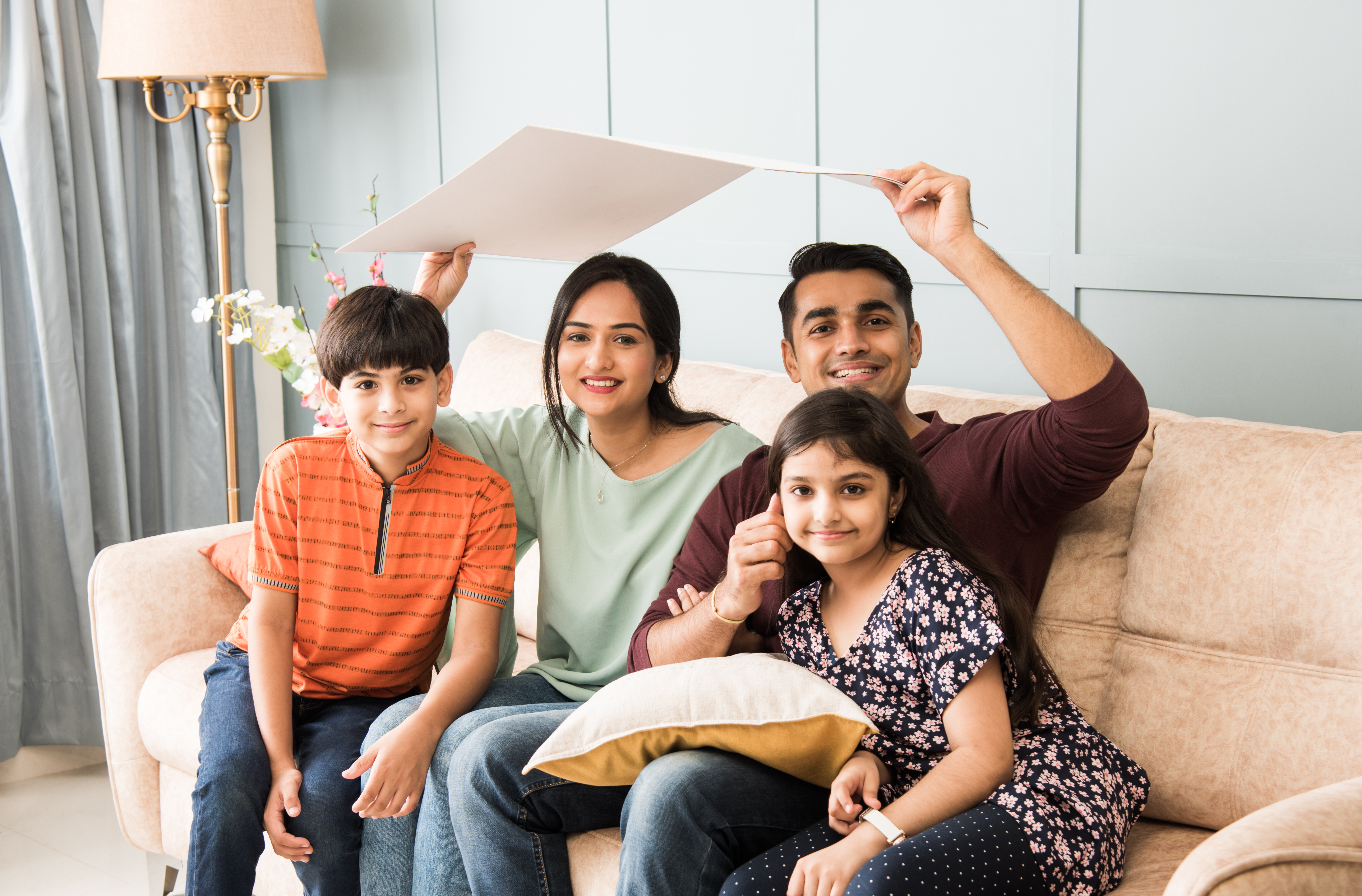 father mother holding house roof